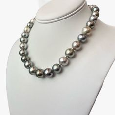 Step into a world of refined allure and grace with this exquisite Tahitian pearls necklace that radiates an undeniable sophistication. Meticulously crafted to perfection, it effortlessly captures attention with its captivating the mix of light pastel hues - golden, silver, light green, and light blue,- emitting a gentle and soothing glow that lends an aura of tranquility to any occasion. This resplendent necklace is finished with rhodium-plated 14K white gold lobster clasp, adorned with tiny dia Luxury Tahitian Pearl Necklace For Formal Occasions, Luxury Single Strand Tahitian Pearl Necklace, Elegant Single Strand Tahitian Pearl Necklace, Luxury Tahitian Pearl Single Strand Necklace, Luxury Tahitian Pearl Necklace, Luxury Tahitian Pearl Necklace With Round Beads, Elegant Tahitian Pearl Jewelry With Round Beads, Elegant Tahitian Pearl Necklace For Formal Occasions, Formal Tahitian Pearl Necklace