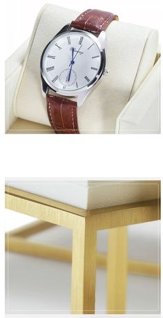 a watch sitting on top of a white cushion next to a wooden table and chair