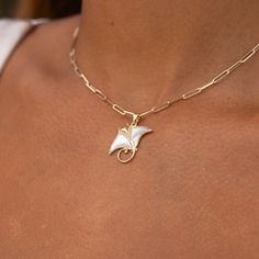 The Manta Ray Pendant from our Sealife Collection features the glowing white mother of pearl, diamonds, and gold. Locally made in Hawaiʻi, this Manta Ray Pendant is a perfect way to commemorate your trip to Maui. Manta Ray Design Pendant 14k Yellow Gold Mother of Pearl, colors may vary Natural Diamonds: 0.066 CTW 21mm in Length Chain not included, Shop Chains Now Exclusively Made in Hawaiʻi Forever Guarantee (Warranty on the life of the piece) Free Shipping on USA Orders $100 or more