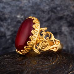 Handmade Gold Plated Red Yemeni Aqeeq Women Ring. Handmade in 925 sterling silver with agate stone. On the ring D-shape Red Aqeeq - Agate stone settled. Gold color plated 925 sterling silver. The dimensions of the stone are 18 mm x 13 mm. The average weight of the Handmade Gold Plated Red Yemeni Aqeeq Women Ring is 8 gr. (depending on your ring size). The back side is open and the stone touches your skin. Classic and exclusive style. Stone Type: Aqeeq - Agate Stone Color: Red Stone Dimensions: 1 Carnelian Jewelry With Polished Finish For Weddings, Elegant Ruby Ring With Polished Agate, Traditional Handmade Ruby Ring For Formal Occasions, Red Carnelian Wedding Jewelry, Handmade Luxury Carnelian Jewelry, Traditional Carnelian Jewelry For Formal Occasions, Traditional Red Ruby Ring For Gift, Elegant Red Rings With Natural Stones, Luxury Handmade Carnelian Jewelry