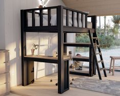 a loft bed with a desk underneath it and stairs to the upper level, in front of a large window