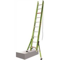 a green ladder sitting on top of a cement block