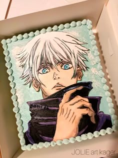 a cake decorated with an anime character holding a cell phone in it's hand