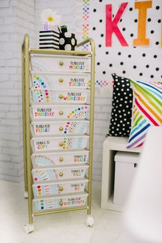 a white drawer with lots of drawers on it in front of a brick wall and polka dot decorations