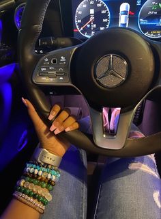 a woman is sitting behind the wheel of a car with her hands on the steering wheel