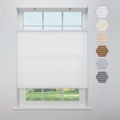 three different shades of white are hanging on the wall in front of an open window