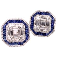 This is a stunning pair of blue sapphire and diamond earrings that has a subtle vintage appeal. It is carefully crafted with round brilliant and baguette diamonds that form the foundation of the earring while the blue sapphire is carefully placed to give a stunning accent. These straight post earrings will be a major hit at your next luncheon or social event! Sapphires: 5.1 cts. Baguettes Diamonds: 3.13 cts. Round Brilliant & Baguette Cut Metal: 18k White Gold Luxury Baguette Cut Earrings For Party, Luxury Blue Diamond Earrings, Luxury Blue Diamond Earrings With Accents, Luxury Blue Baguette Cut Earrings, Luxury Blue Diamond Earrings With Brilliant Cut, Blue Sapphire Diamond Earrings Gia Certified, Blue Diamond Earrings With Diamond Accents, Blue Diamond Earrings With Accents, Blue Diamond Earrings With Pave Setting