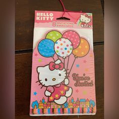 a hello kitty birthday party bag with balloons