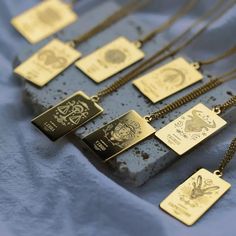 a group of necklaces sitting on top of a blue cloth