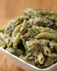 pasta with spinach and meat in a white bowl