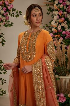 Peach orange georgette long anarkali with intricate gota work in floral pattern. Comes with matching salwar and pure organza dupatta.
Components: 3
Pattern: Embroidered
Type Of Work: Gota
Neckline: Round
Sleeve Type: Three Quarter
Fabric: Anarkali and Salwar: Georgette, Dupatta: Organza
Color: Peach,Orange
Other Details: 
Embellished show buttons
Kiran border dupatta
Model height: 5ft 7inches, wearing size S
Closure:
Kurta: Front hook and eye
Salwar: Drawstring tie-up
Occasion: Wedding,Puja - Az Anarkali Style Peach Palazzo Set With Resham Embroidery, Traditional Orange Sharara With Sheer Dupatta, Bollywood Style Orange Chinon Dupatta, Peach Semi-stitched Floor-length Sharara, Peach Anarkali Set With Sheer Dupatta, Orange Bollywood Style Chinon Dupatta, Bollywood Orange Chinon Dupatta, Orange Chinon Bollywood Dupatta, Floor-length Peach Sharara