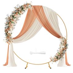 a wedding arch decorated with flowers and ribbons