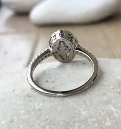 a diamond ring sitting on top of a rock