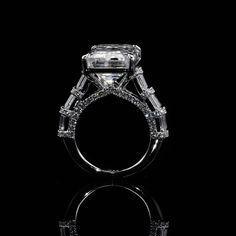 a diamond engagement ring on a black background