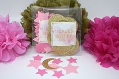 some pink and gold decorations on a white table