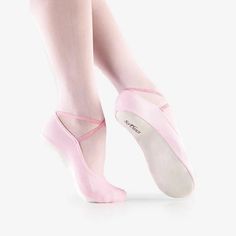 a woman in pink ballet shoes with her feet up