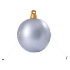 a silver christmas ornament hanging on a string