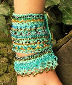 a close up of a person's hand wearing a bracelet made out of beads