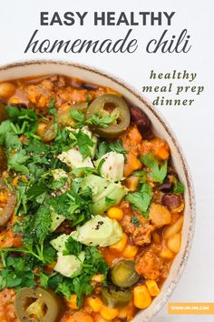 a bowl filled with meat and vegetables on top of a table