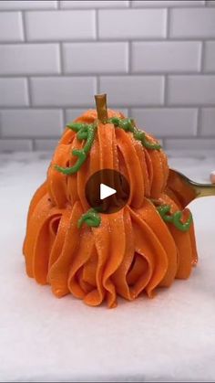 a video demonstrating how to make a pumpkin shaped pasta dish with googly eyes and green sprinkles