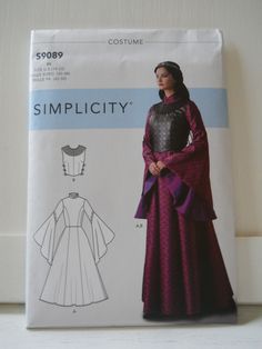 Simplicity S9089 R5 sewing pattern in sizes 14, 16, 18, 20 and 22. This pattern is for a fitted dress, with princess seams, down through it's floor length, full skirt. It has very full sleeves and a high neckline with a stand-up collar. There is also a fitted corset or bodice that ties at the sides, and has a high, decorative collar. This is a very modest, but flattering Renaissance festival appropriate costume, or fantasy costume. It would be beautiful for a queen, princess, empress, or even a High Neck Corset, Garden Trellis Designs, Pattern For Dress, Dress With High Neck, Neck Corset, Hanging Quilts, Queen Princess, Costume Patterns, Fantasy Costumes