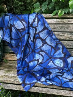 This beautiful, hand painted silk scarf is a wearable piece of art. Butterflies, in shade of blue, and outlined in black, have been hand painted onto the silk with specialist silk paint. The outline of the design is first drawn and then the colours are applied with brushes - the whole process takes many very enjoyable hours. The scarf has been professionally streamed in order to permanently fix the colours and preserve their vibrancy. This steaming process leaves the silk particularly soft and floaty with an almost fluid-like quality.  The scarf would make a lovely birthday gift or silk anniversary present. It could be worn casually or more formally for a summer wedding or party. The measurements of the scarf are approximately 180cm by 45cm This scarf will come gift wrapped at no extra cha Summer Blue Silk Scarf, Hand Painted Butterfly, Art Butterflies, Painted Butterfly, Butterfly Scarf, Long Silk Scarf, Silk Scarf Painting, Hand Painted Silk Scarf, Scarf For Women