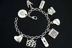 "A collection of silver plated aunt, love, and family themed charms have been dispersed around a shimmering silver plated bracelet chain in this handmade charm bracelet. This aunt themed charm bracelet is then completed with a lobster clasp and a 1/2 inch of chain at the end for adjustable sizing. Charms in this bracelet include a \"live laugh love\" charm, an ASL \"I love you\" charm, a \"family\" tab charm, an \"I love you\" letter charm, an \"aunt\" heart charm, \"A family's strength lies in Valentine's Day Alloy Charm Bracelet Gift, Valentine's Day Gift Alloy Charm Bracelet, Valentine's Day Alloy Charm Bracelet, Mother's Day Dangle Charm Bracelet, Silver Charms For Friendship On Valentine's Day, Silver Charms For Mother's Day Personalized Gift, Personalized Silver Charm Bracelet For Gift, Personalized Silver Charm Bracelet For Anniversary, Sterling Silver Charm Bracelet For Friendship On Mother's Day