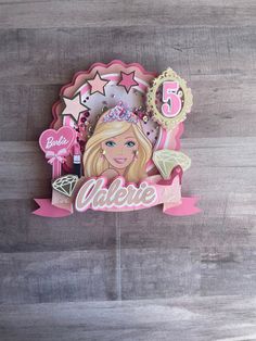 a birthday cake topper with a barbie doll on it