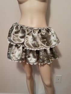 "This is a short 2 tier ruffle skirt with an elastic drawstring closure. It is a sage green color with a subtle dragonfly print. It is 13\" long and the widest the waist expands to is 32\".  Super cute and flirty." Green Flowy Mini Skirt With Ruffles, Green Tiered Ruffle Skort, Harajuku Style Ruffled Tiered Mini Skirt, Harajuku Style Tiered Ruffled Mini Skirt, Black Bolero Jacket, Harajuku Mini Skirt With Ruffled, Tiered Design, Dragonfly Prints, Tiered Ruffle Skirt, Sequin Tank