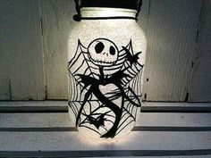 a halloween jar with a jack skellingy face on it