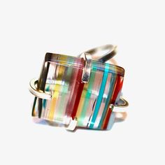 This Surfite ring is simply rainbow perfection! A large Surfite cabochon is prong set in a sterling silver adjustable ring setting. Surfite is made from overspill to the surf board making process. This comes from California and is repurposed and polished into amazing cabochons. This ring is adjustable and best for US ring sizes from 5-10. xoxoxo payton All FizzCandy creations come beautifully boxed and ready for gift giving. Modern Rainbow Round Jewelry, Modern Multicolor Gemstone Jewelry, Modern Round Rainbow Jewelry, Modern Adjustable Multicolor Jewelry, Unique Multicolor Rings With Polished Finish, Modern Multicolor Rectangular Jewelry, Multicolor Polished Ring Jewelry, Multicolor Polished Finish Ring Jewelry, Multicolor Polished Rings For Gifts