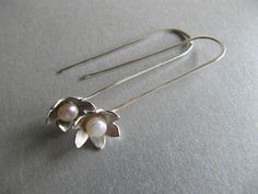 "These long earrings are made with a little white pearl sitting in the center of a flower at the end of a long handmade wire. Flower measures 10mm across 1 3/4\" long Simple and pretty." Sterling Silver Flower Earrings With Pearl Drop, Sterling Silver Flower Earrings, Freshwater Pearl Drop Earrings, Long Flowers, Silver Flower Earrings, Sterling Silver Brooch, Braided Hair, Handmade Jewelry Gift, Upcycled Jewelry