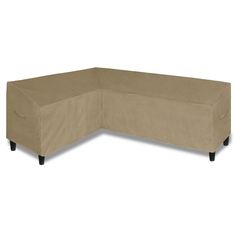 a large sectional couch with black legs and a beige cover on it's back