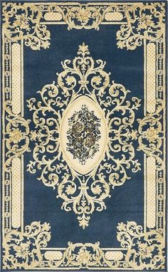 a blue rug with gold trimmings and an ornate design on the bottom corner