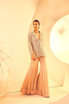 Featuring a hand embroidered blazer with flared sharara pants. It Is embroidered with Cutdana, bead and sequins embroidary. From Aneesh Agarwaal's Naksh collection. DELIVERY TIMEPlease allow 8-12 weeks for your outfit to arrive. FABRIC DETAILSChiffon - Sharara, Jacket - Net Professional cleaning only. Sharara Jacket, Jacket Sharara, Taupe Blazer, Flared Sharara, Sharara Pants, Embroidered Blazer, Navratri Dress, Gold Jacket, Palazzo Set