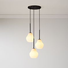 three lights hanging from a ceiling in a room