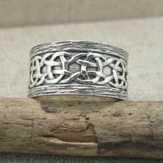 Celtic Scavaig Wedding Ring Continuous Celtic Weave Design on Sterling Silver Ring. 11 mm wide and stamped 10K & .925 (Sterling Silver). Oxidized background with bark edges. Available in whole and half sizes 5 to 13. (custom orders up to size 15) Nicely boxed with silver cloth. Ships in 3 to 5 days. Symbolic Intricate Design Jewelry For Anniversary, Unique Etched Jewelry For Wedding, Symbolic Wedding Jewelry With Intricate Design, Unique Etched Wedding Jewelry, Ceremonial Engraved Round Band Jewelry, Unique Decorative Band Jewelry Gift, Heirloom Band Jewelry As Gift, Traditional Band Jewelry As Gift, Unique Jewelry With Decorative Band As Gift