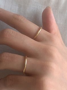 Editor's Notesbyweekend presents an essential round ring with a glossy surface. It is a simple yet, feminine item that stands out. - Plain round ring- Plain glossy surface- Made of silver 925- 18K gold plated- Sleek silhouette- Simple and basic style Measurements(in.)- Size: 3 / 5 / 7 / 9 / 11 / 13 / 15 / 17 / 19 Composition & Care- Material: Silver 925, 18K Gold Plating- Plated products may discolor over time due to their nature.- Please be careful that discoloratio Basic Rings Simple, Classic Adjustable Dome Ring For Everyday Wear, Adjustable Elegant Dome Ring For Everyday Wear, Classic Adjustable Dome Ring For Everyday, Elegant Adjustable Dome Ring For Everyday, Minimalist 14k Gold Couple Rings With Simple Design, Plain Rings Gold For Women, Adjustable Rings For Everyday Wear, Elegant Open Band Dome Ring For Everyday