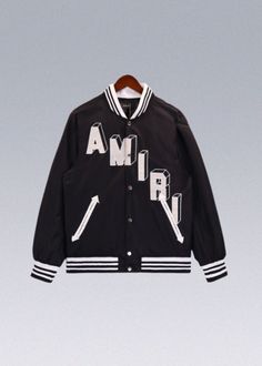 AMIRI Bone Varsity Jackets Featuring an exquisite embroidery LOGO, these jackets showcase your unique style with flair. The standout feature of this AMIRI Bone Varsity Jackets is the attention-grabbing skeleton design on the sleeves, adding an edgy and fashionable touch to your outfit. The double zipper closure not only adds a trendy element but also provides practicality and convenience. - HIGHLIGHT: Embroidery LOGO Skeleton on sleeves Double zipper closure Faux wool jacket - Size:(cm) Size Height(cm) Weight(kg) M 160-170cm 40-60kg L 170-180cm 60-70kg XL 175-185cm 70-85kg Black Outerwear With Embroidered Graphics And Long Sleeves, Black Long Sleeve Outerwear With Embroidered Graphics, Fall Outerwear With Embroidered Graphics And Long Sleeves, Fall Long Sleeve Outerwear With Embroidered Graphics, Hooded Outerwear With Embroidered Graphics For Fall, Black Outerwear With Letter Embroidery For Spring, Trendy Black Outerwear With Letter Embroidery, Trendy Long Sleeve Outerwear With Embroidered Graphics, Black Spring Outerwear With Letter Embroidery