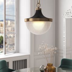 a dining room table with blue chairs and a chandelier hanging from the ceiling