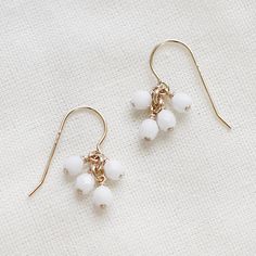 lucky in white  faceted gold earrings by elephantine on Etsy Minimalist White Beaded Dangle Earrings, White Pearl Drop Dangle Cluster Earrings, Delicate White Jewelry With Dangling Beads, White Pearl Drop Cluster Earrings, Minimalist White Beaded Drop Earrings, White Dangle Earrings With French Hook, Minimalist White Earrings With French Hook, White Minimalist French Hook Earrings, Simple White Drop Earrings