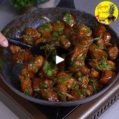 someone is cooking some food in a pan on top of the stove with a spatula