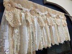 an old fashioned lace curtain is hanging on the wall