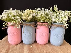 three mason jars with baby's breath flowers in them