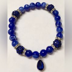 A Stunning Stretchy Bracelet With Gorgeous Royal Blue Beads With White Streaks, Beautiful Royal Blue Rhinestone Crystal Ball Beads, Silver Rhinestone Spacers, And A Silver Plated Royal Blue Tear Drop Charm Nwot- Never Worn Or Used From A Smoke Free Home *Specially Handcrafted Elegant Blue Stretch Bracelet With Faceted Beads, Blue Crystal Bracelet With Rhinestones, Elegant Blue Beaded Crystal Bracelet, Adjustable Blue Crystal Bracelet With Stones, Adjustable Blue Beaded Bracelets With Rhinestones, Blue Crystal Beaded Bracelets With Faceted Beads, Blue Crystal Bracelet With Round Beads, Blue Crystal Bracelet With Polished Round Beads, Blue Crystal Jewelry With Gemstone Beads