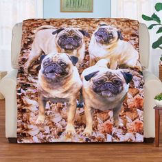 three pug dogs sitting on top of leaves in the middle of a living room