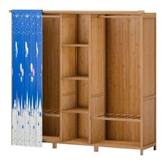 an open wooden wardrobe next to a curtain