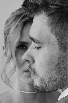 black and white photograph of a man and woman looking into each other's eyes