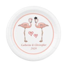 a paper plate with two pink flamingos on it