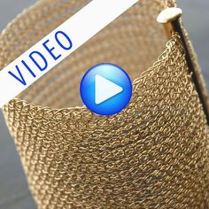 a close up of a woven basket with a video sign in the center and an arrow pointing to it